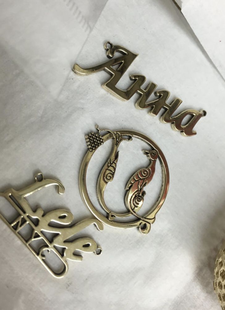 Laser cut brass name pendant and decorative bird charm