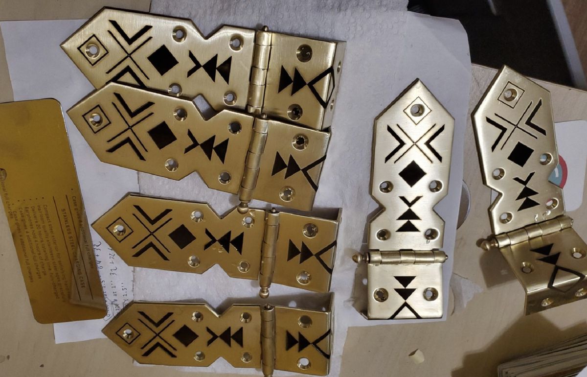 Set of brass hinges with geometric patterns laser cut and engraved into them