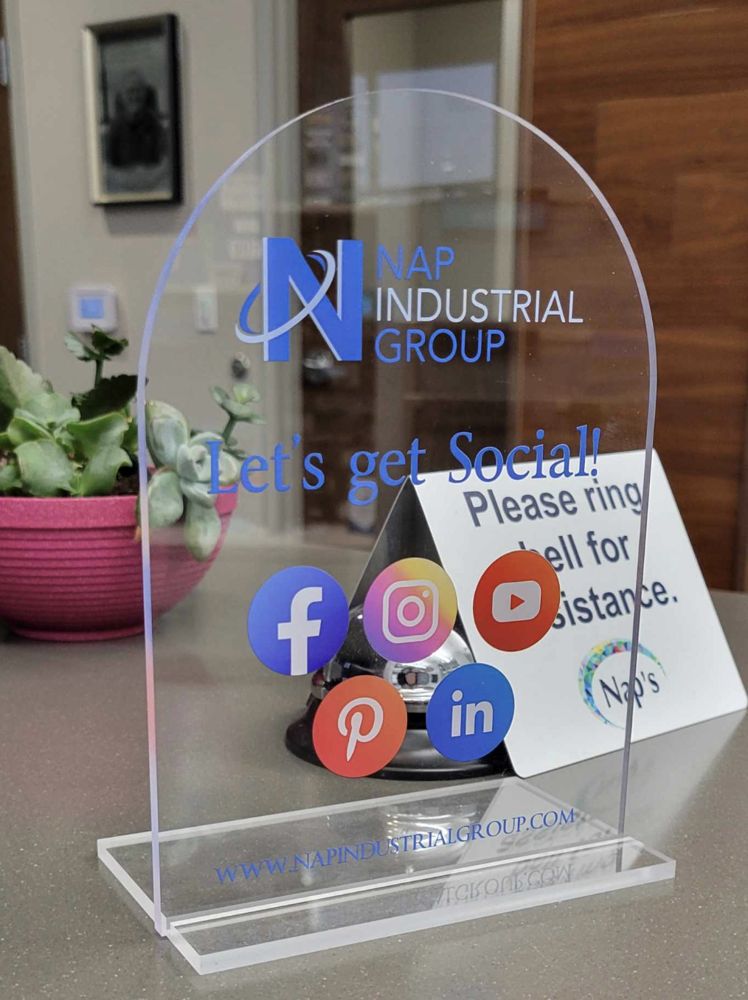 Arched clear acrylic table sign printed with a company logo and social media icons
