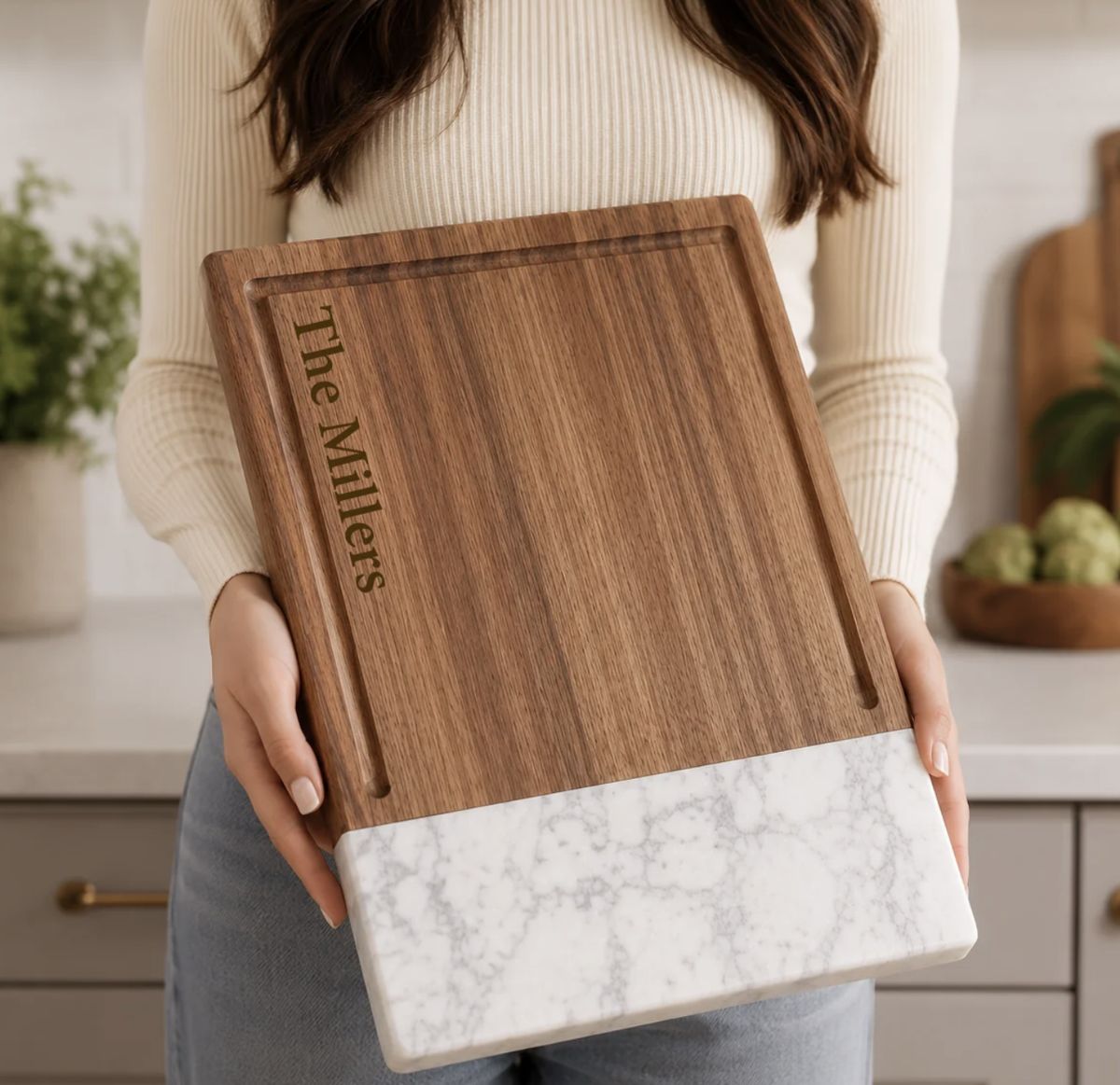 Walnut and marble cutting board engraved with a family name